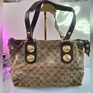 Elegant Brown Shoulder Bag with Monogram Pattern and Gold Accents